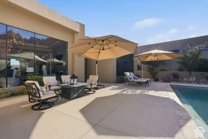 Expansive outdoor patio with concrete surfacing and an integrated swimming pool