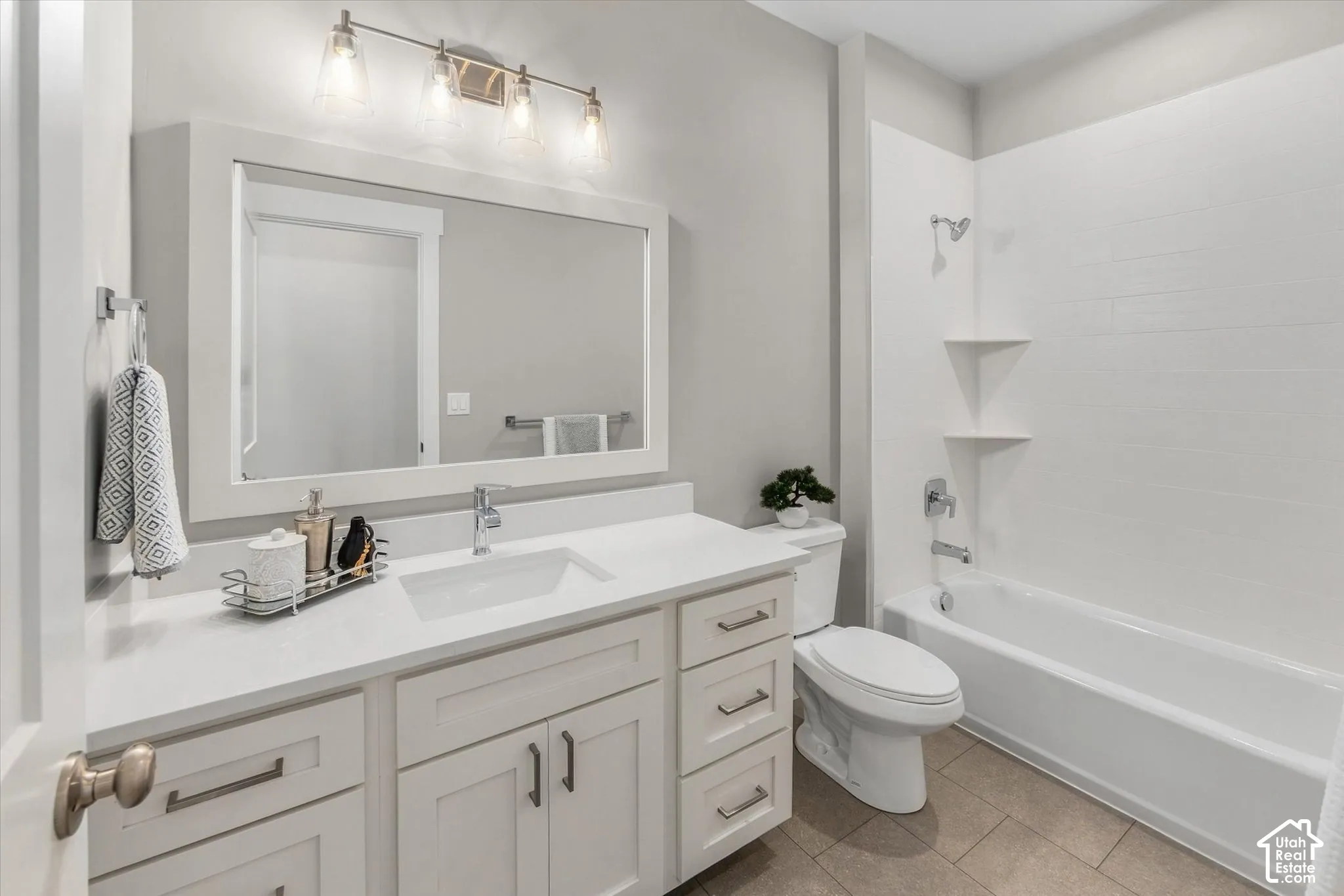 White vanity with rectangular sink, polished chrome faucet, and integrated storage