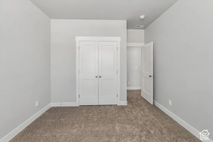 Neutral wall color, light-toned carpet, white trim, and white doors