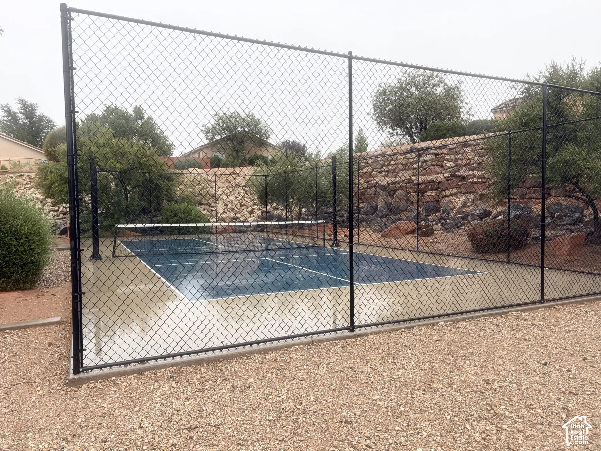 Enclosed sports court featuring a blue playing surface and white boundary lines
