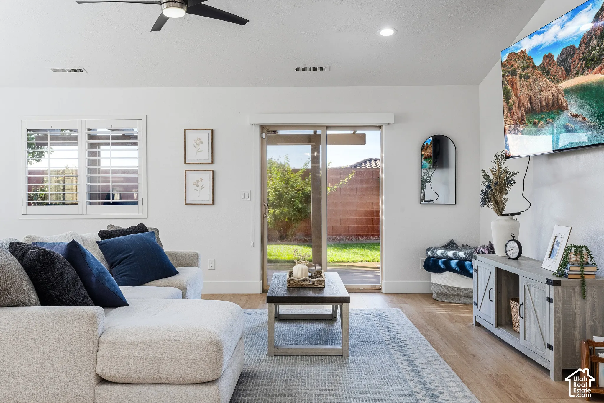 Recessed lighting, ceiling fan, wood-finish flooring, sliding glass door, plantation shutters