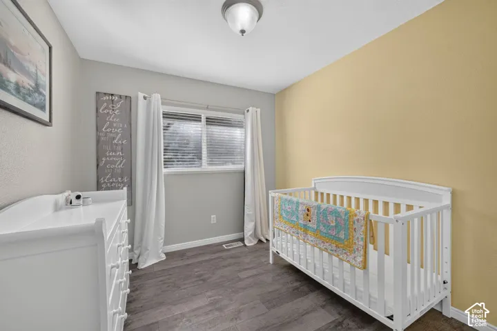 Wood-finish flooring, overhead flush mount lighting, and a window with blinds