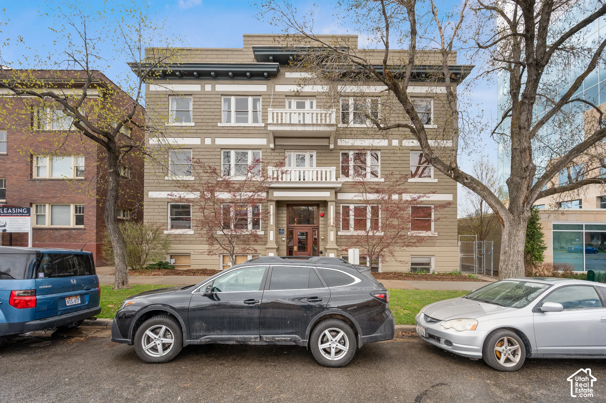 Multi-story building featuring balconies, decorative corbels, and a prominent entry