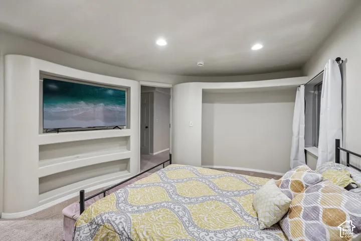 Built-in media niche with shelving, recessed lighting, and curved architectural wall details