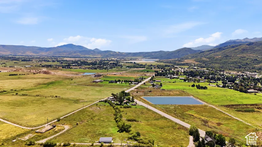Expansive land parcel with surrounding agricultural fields and distant mountain ranges