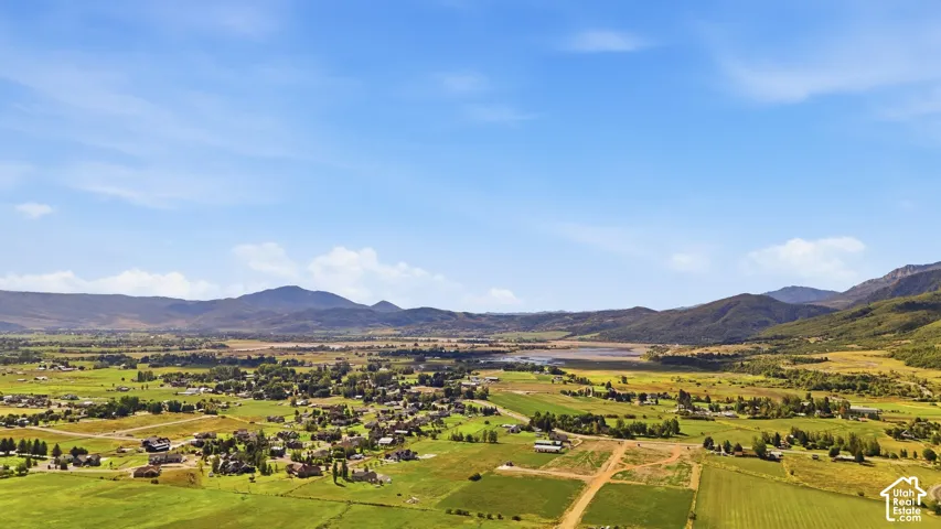 Expansive valley setting with distant mountains and a central body of water