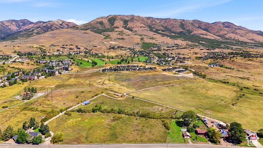 Mountainous terrain backdrop featuring varied topography and distant residential developments