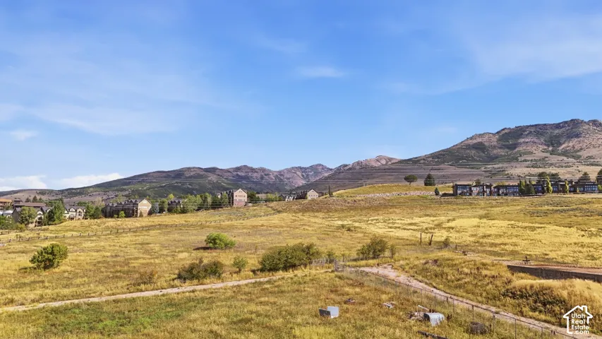Expansive open terrain featuring natural vegetation and distant mountain ranges