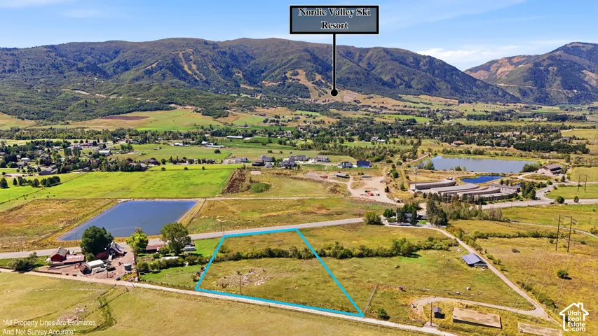 Expansive land parcel featuring open fields and distant mountain ranges