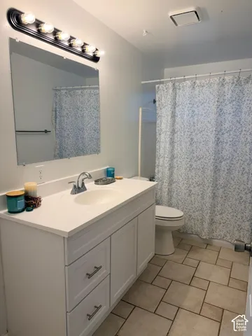 White vanity with integrated sink, chrome faucet, and contemporary hardware