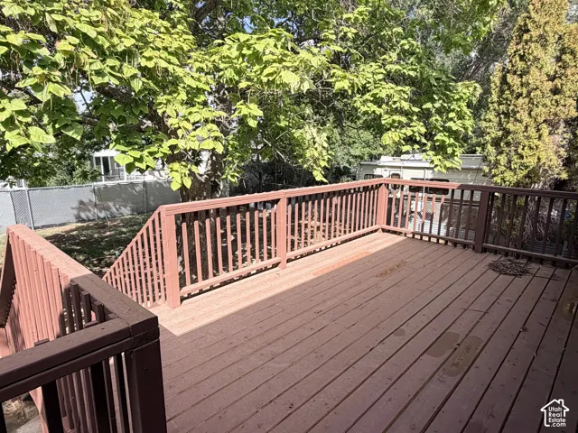 Expansive wood deck with a built-in railing system, providing outdoor living space