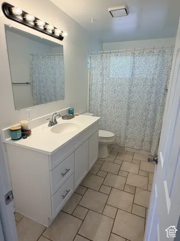 White vanity with integrated sink and chrome faucet