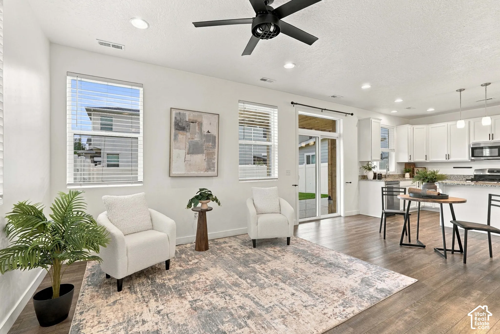 Open concept living area featuring wood-finish flooring, recessed lighting, and a ceiling fan