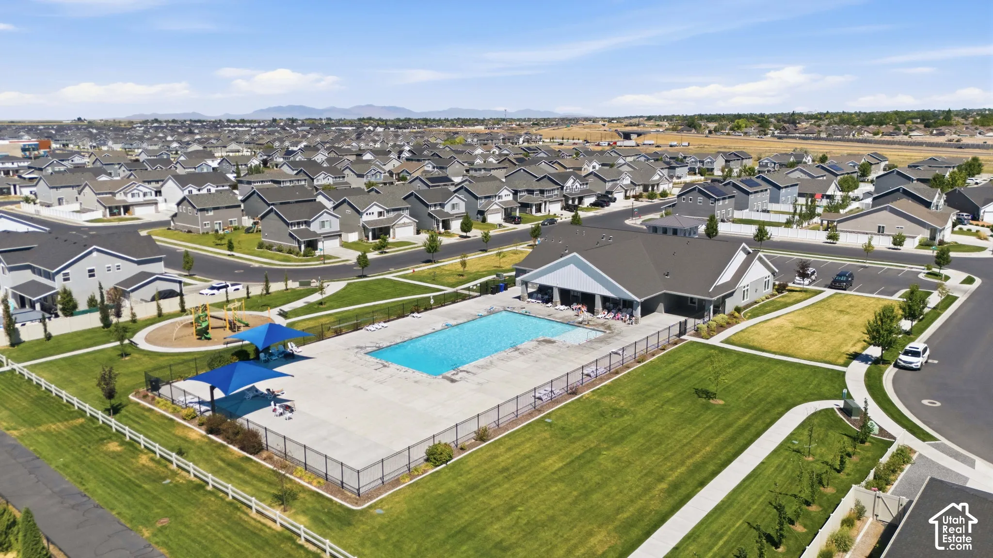 Community amenities featuring an outdoor swimming pool, a dedicated clubhouse, and a playground with shade structures