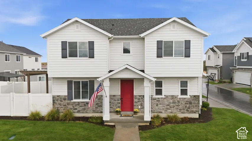 White siding facade with a red entry door