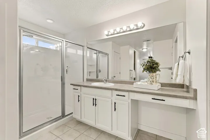 Walk-in shower with clear glass enclosure and transom window