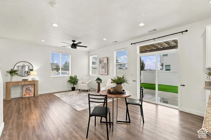 Recessed lighting, wood-finish flooring, and white walls