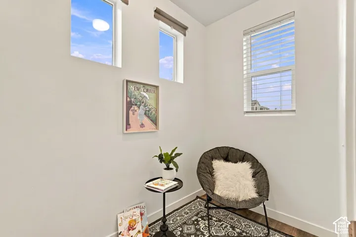 White walls with multiple windows, including transom windows, and wood-finish flooring