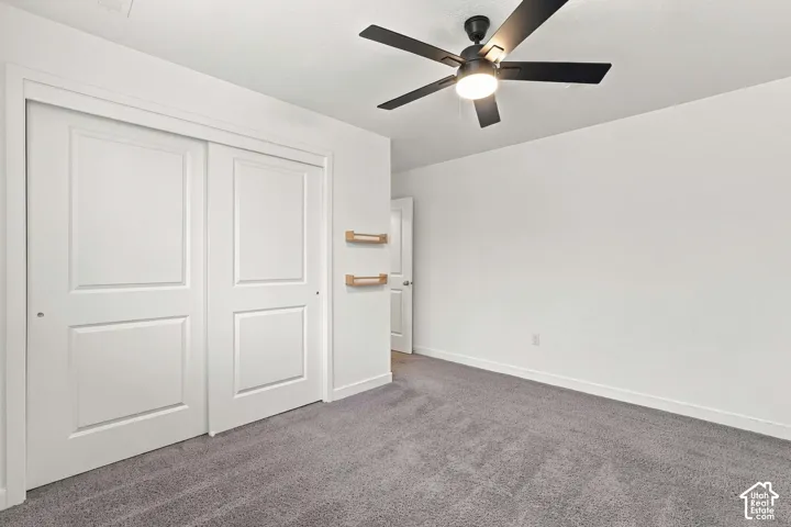 Recessed lighting, ceiling fan with integrated light, neutral carpeting, white trim work, and white paneled doors