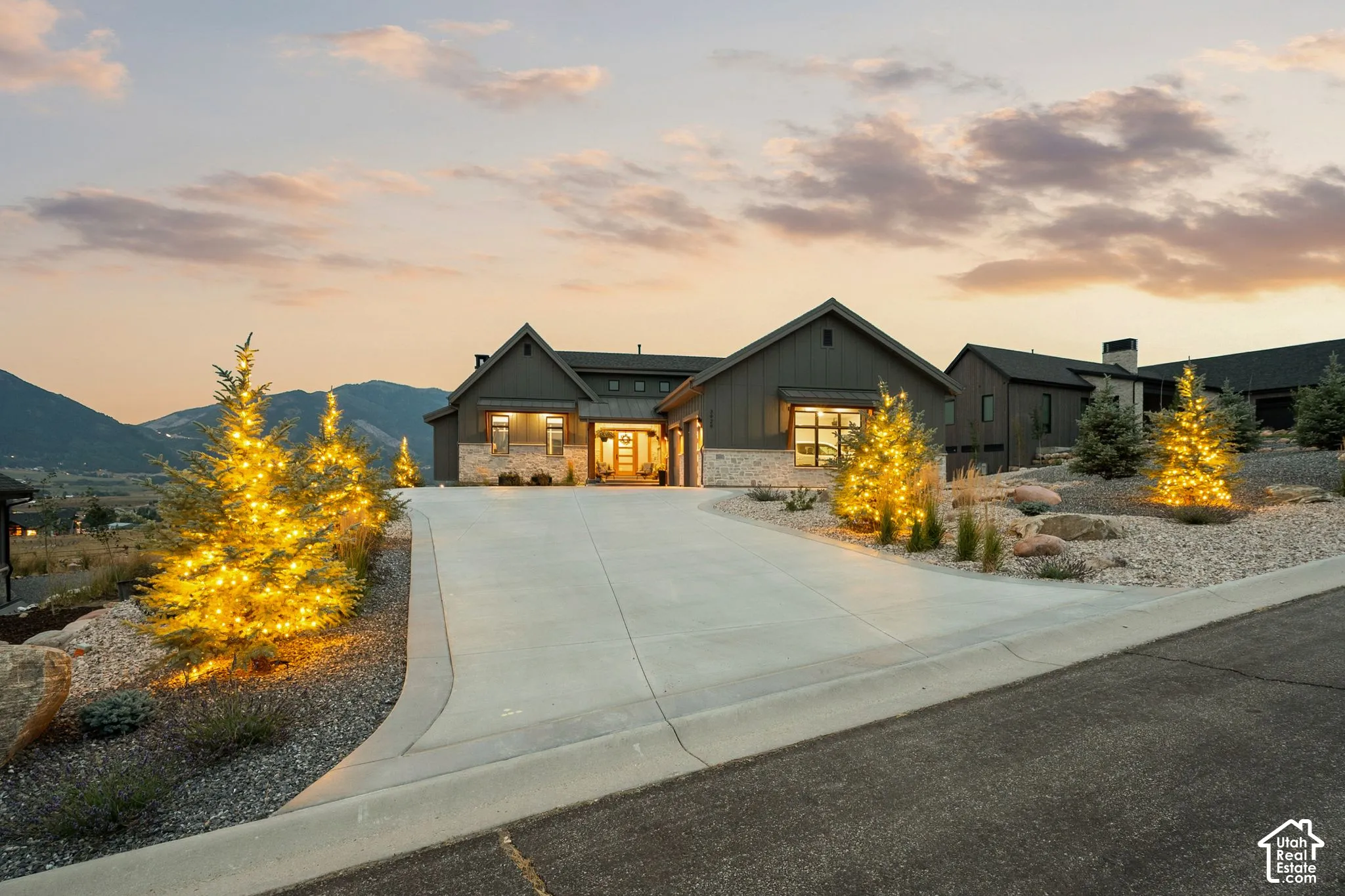 Contemporary exterior featuring horizontal siding, stone accents, and a multi-level roofline