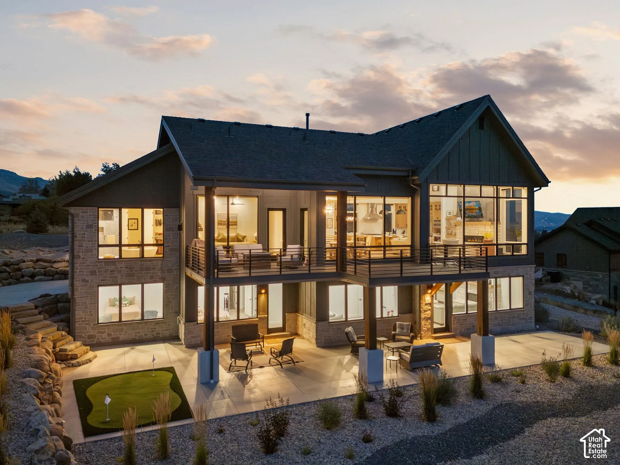 Multi-level exterior with stone and vertical siding accents