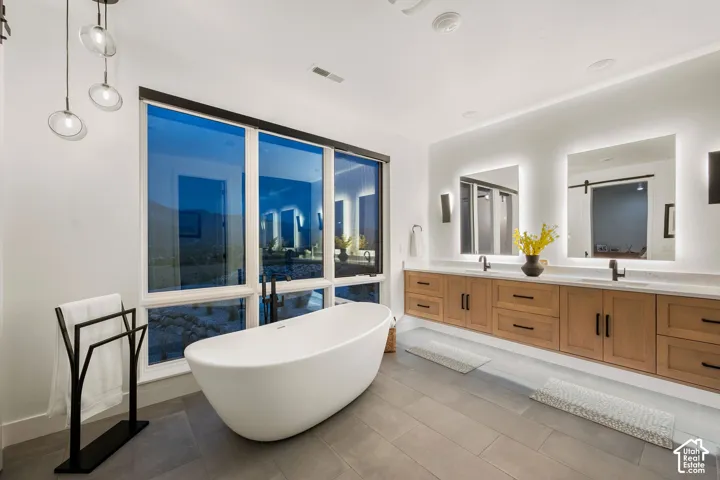 Freestanding soaking tub with floor-mounted faucet