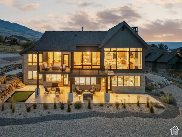 Stone and siding exterior with multiple balconies and expansive windows