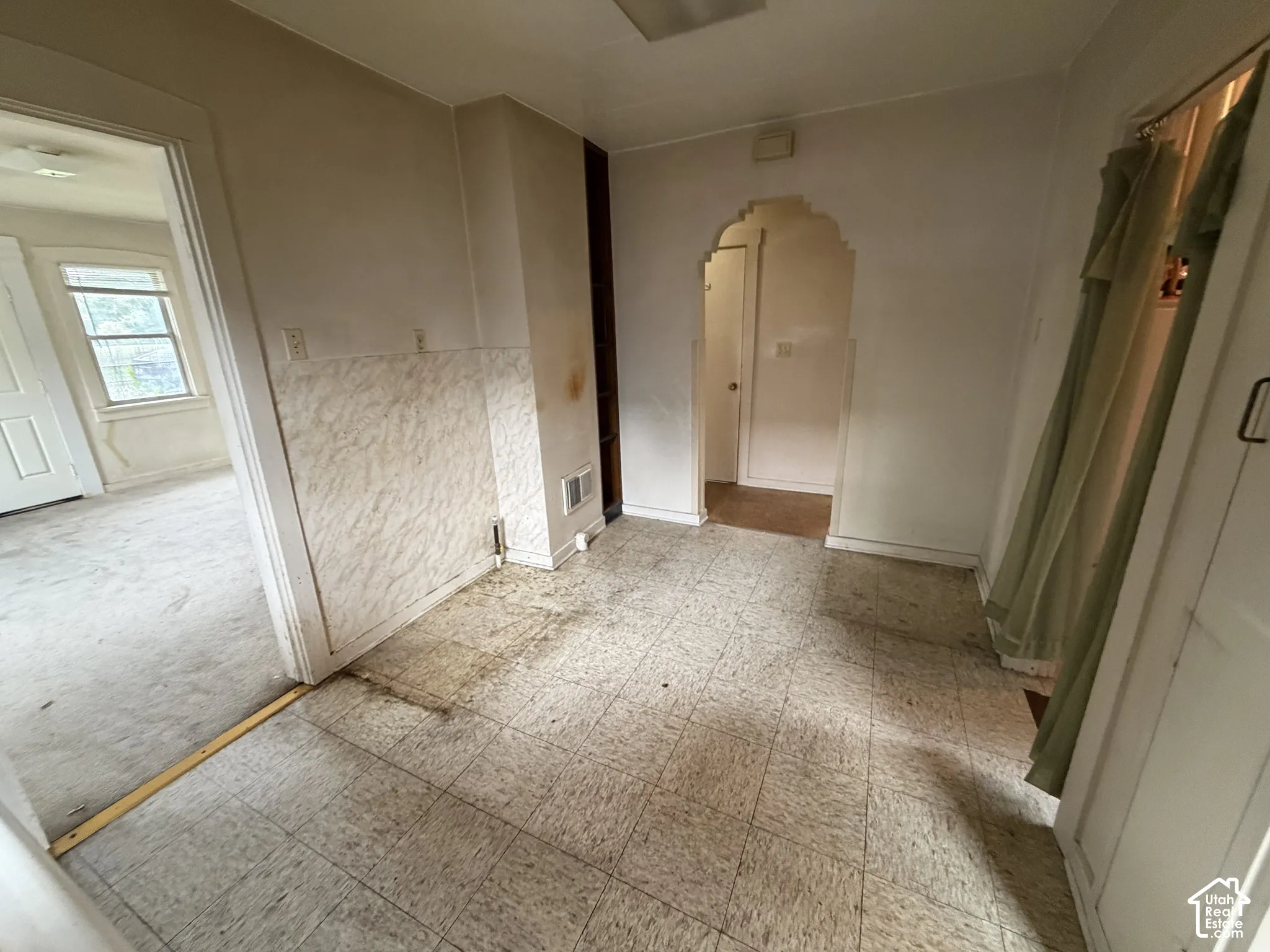 Interior space with tiled flooring and an arched doorway
