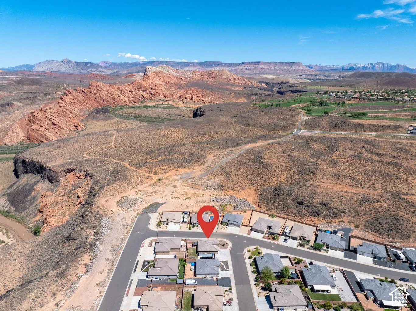 Residential property located within a developed community featuring paved roads and residential structures