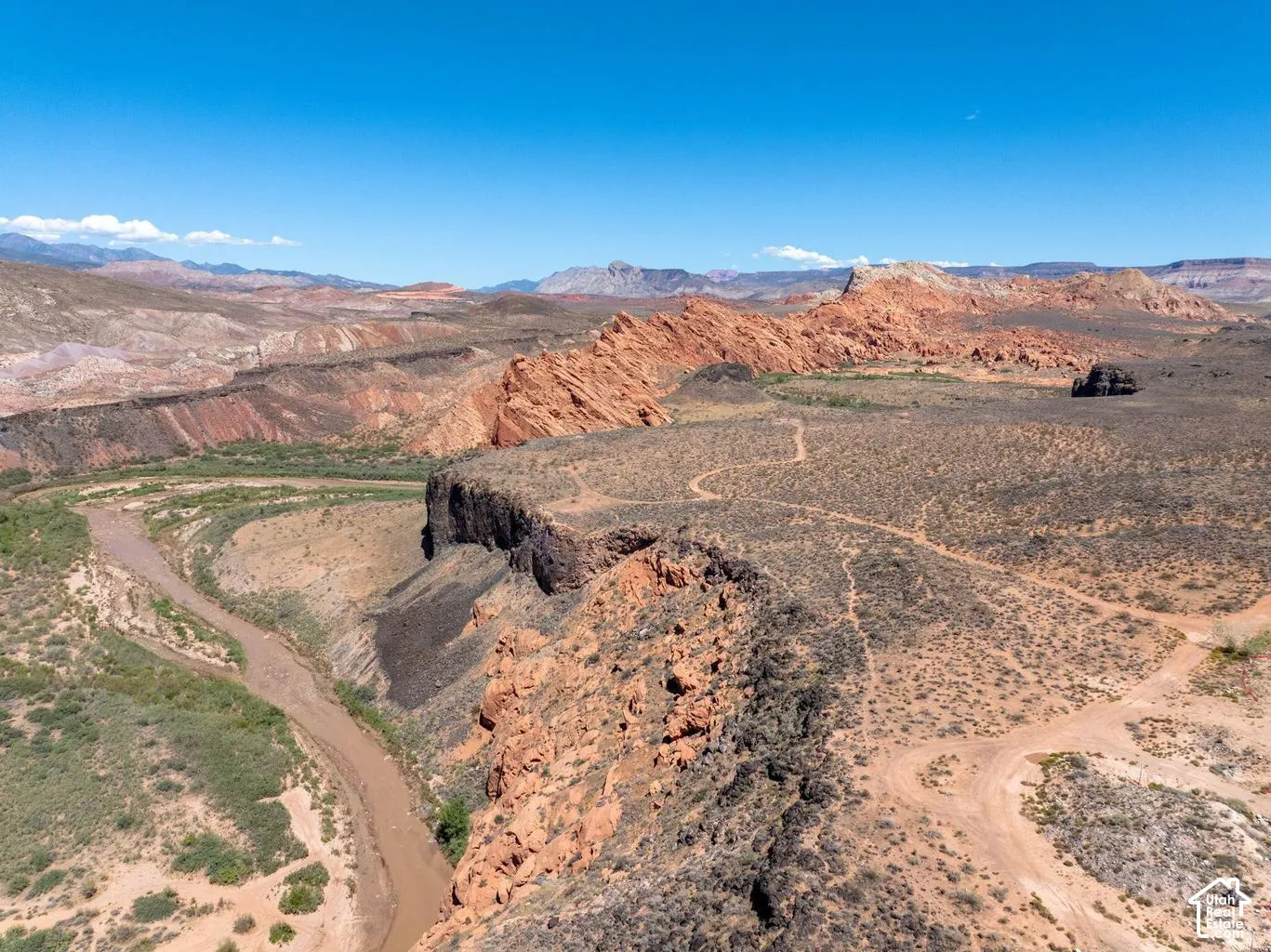 Arid landscape featuring a winding river, rock formations, and visible terrain