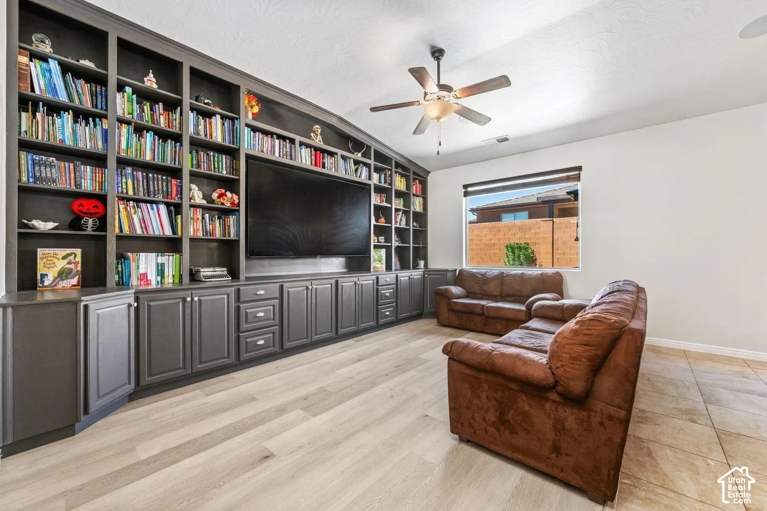 Custom built-in cabinetry with ample shelving and integrated media console
