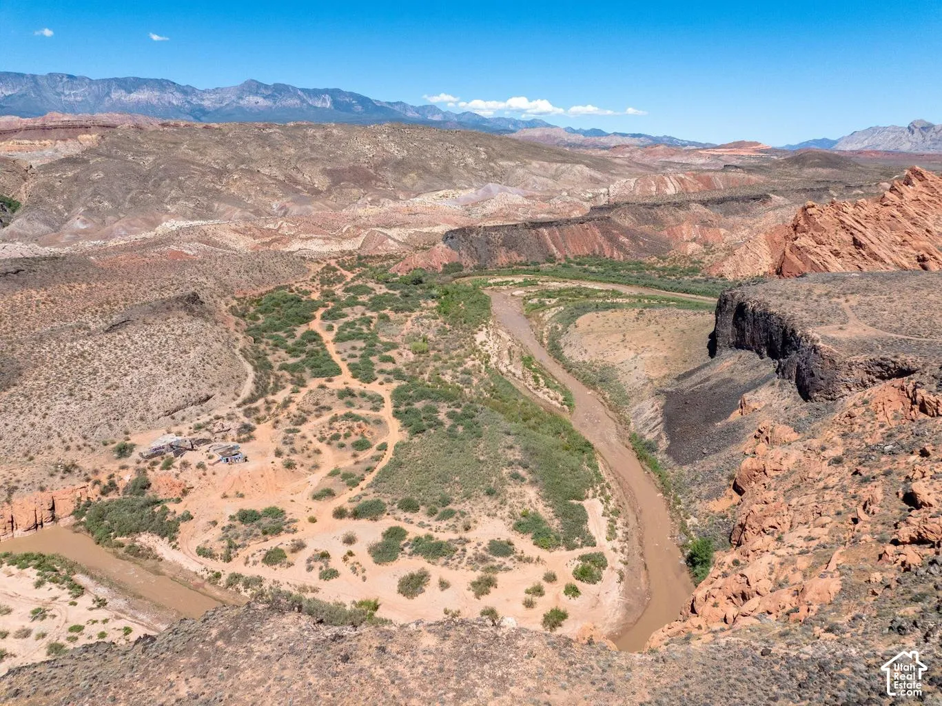 Expansive natural landscape with a winding river and distant mountain range