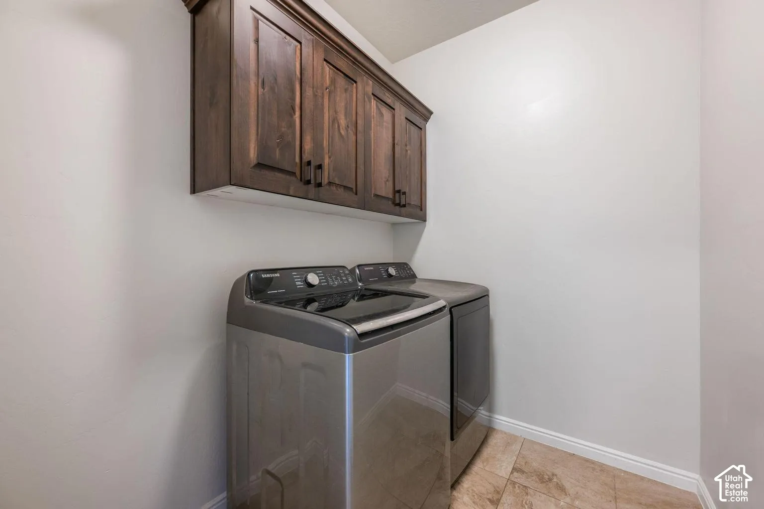 Wood-finish cabinetry with dark hardware
