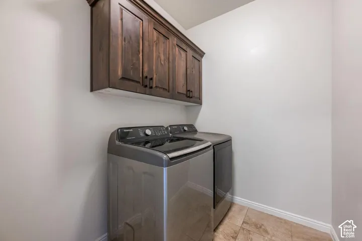Wood-finish cabinetry with dark hardware