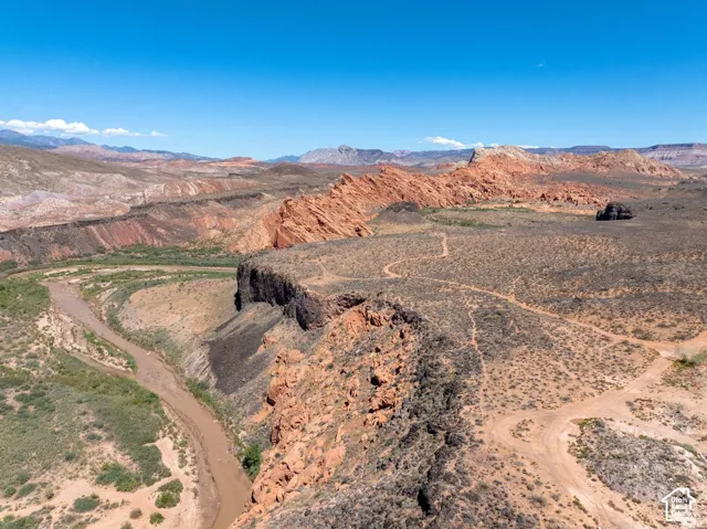 Arid landscape featuring a winding river, rock formations, and visible terrain