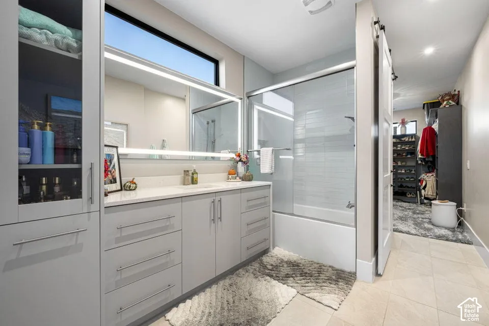 Vanity with a quartz-look countertop, integrated sink, and undermount cabinetry