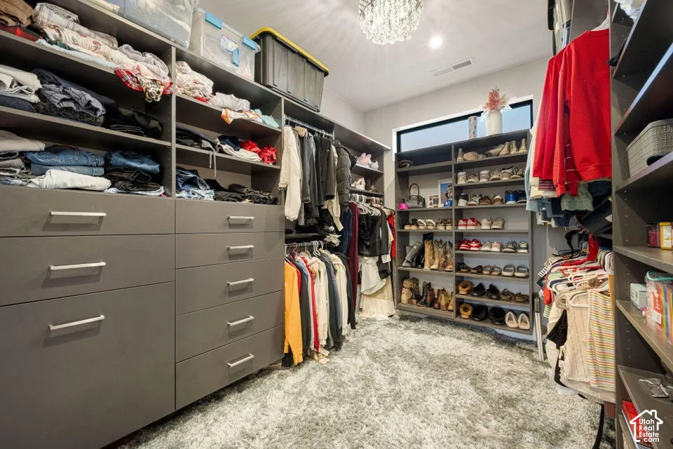 Custom closet organization system with built-in drawers, open shelving, and hanging rods