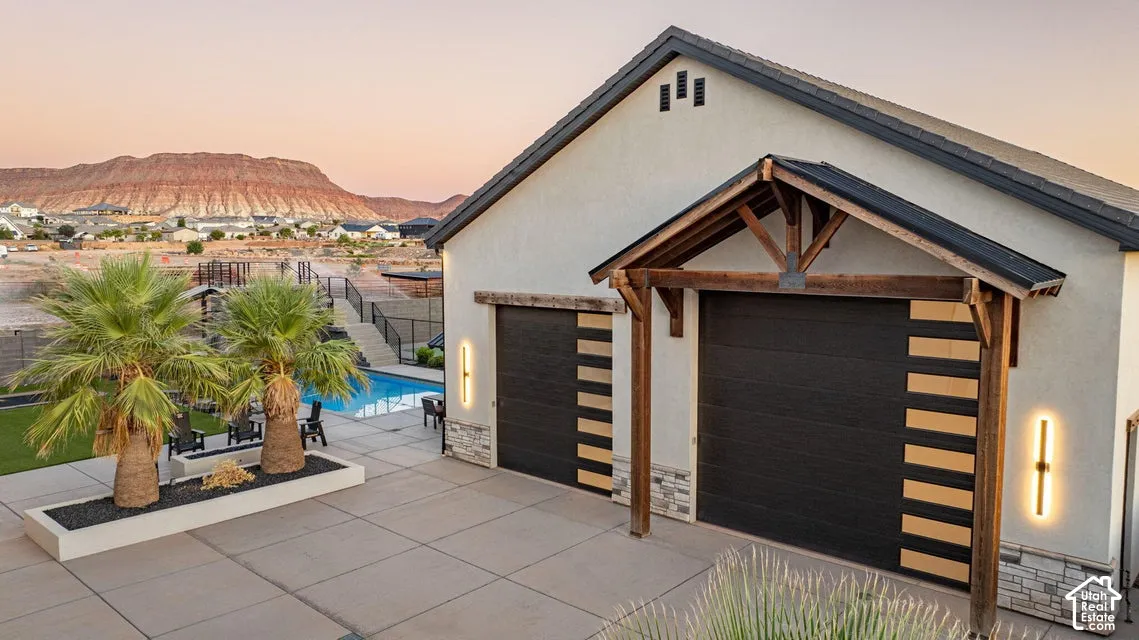 Stucco exterior with a pitched roofline, accented by a decorative wood-framed entryway