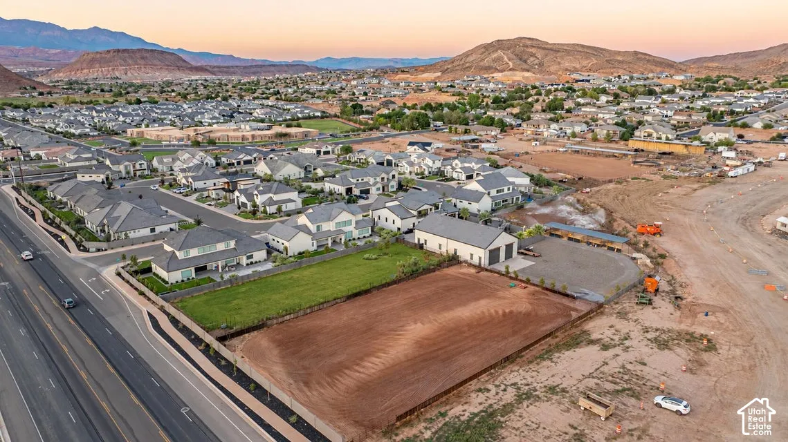 Expansive lot with substantial frontage, featuring a partially graded surface and a perimeter fence