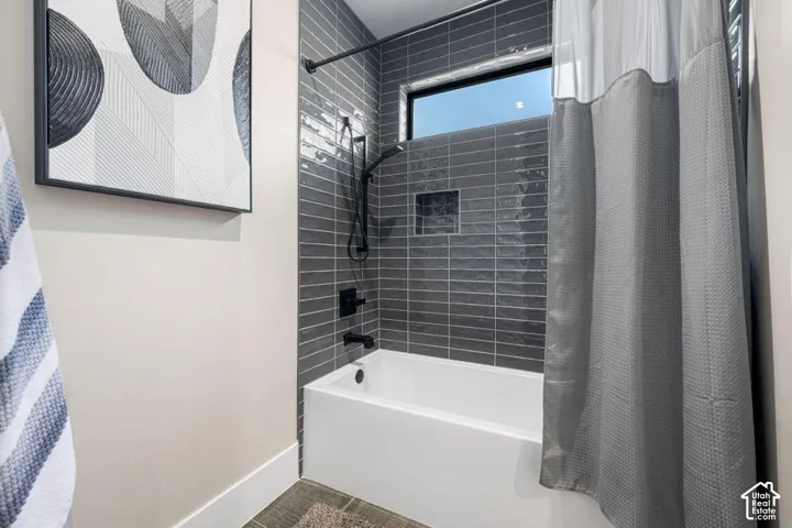 Tile-surround bathtub with matte black fixtures