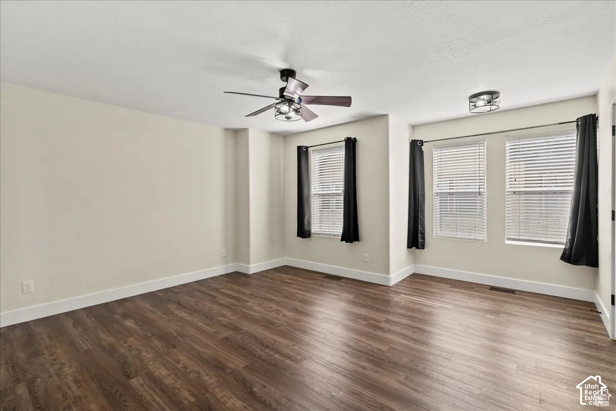 Master bedroom. Wood-finish flooring, multiple windows with blinds, ceiling fan, and recessed lighting