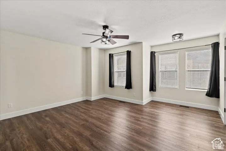 Master bedroom. Wood-finish flooring, multiple windows with blinds, ceiling fan, and recessed lighting