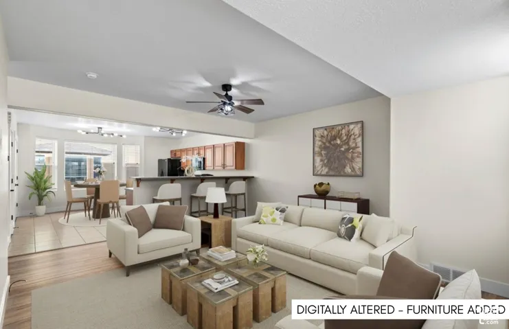 Open-concept living area with wood-finish flooring, a ceiling fan, and recessed lighting
