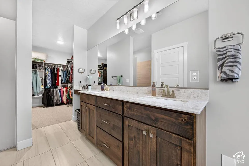 Double vanity with wood-finish cabinetry and light-toned countertops