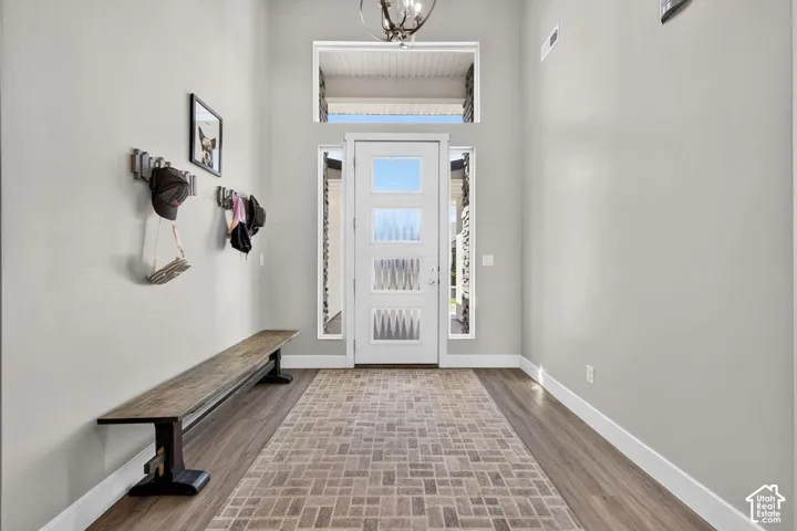 Entryway featuring a decorative pendant light, transom window, and side lite windows