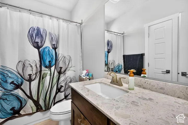 White drop-in sink with a bronze-finish faucet, set into a speckled countertop