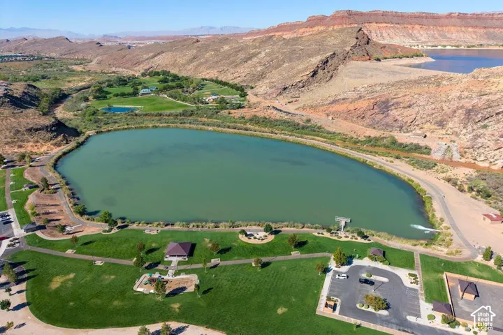Expansive green parkland featuring a large lake