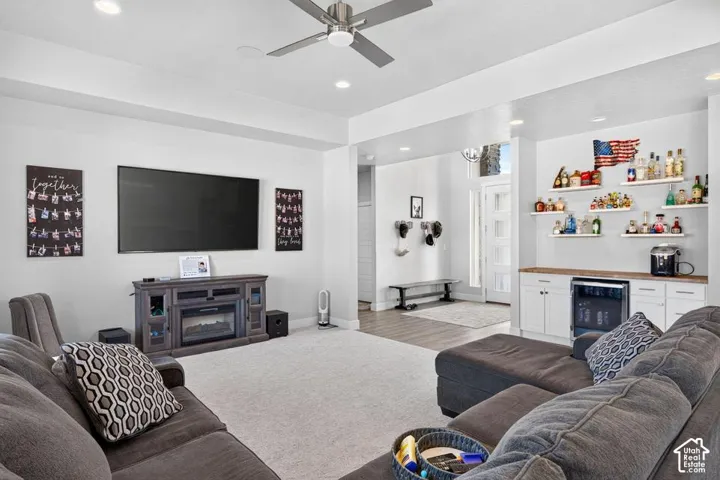Spacious living area featuring recessed lighting, a ceiling fan, and a built-in entertainment console with an electric fireplace