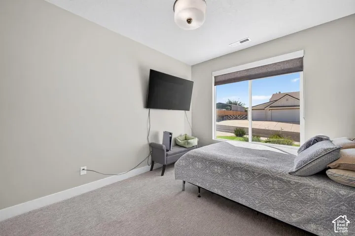 Carpeted room with a flush-mount ceiling light and light gray walls