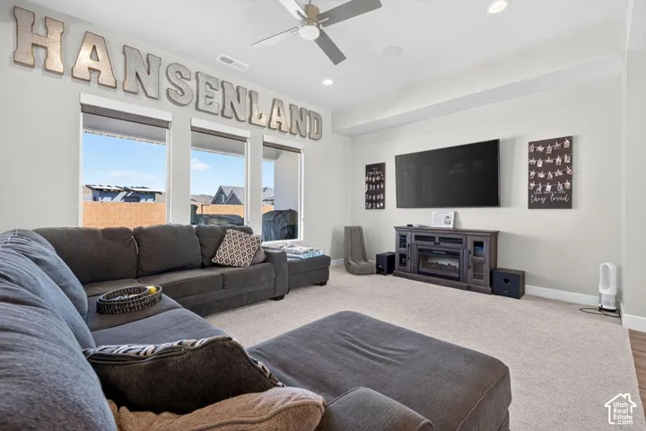 Recessed lighting, ceiling fan, carpet flooring, base molding, and multiple windows